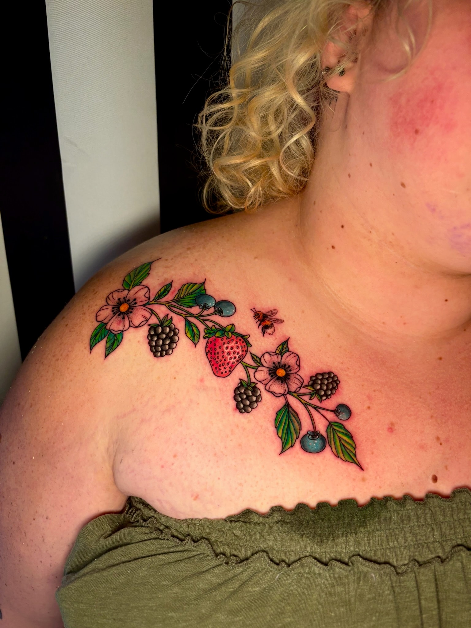 Colorful berry and flower shoulder tattoo, traditional color
