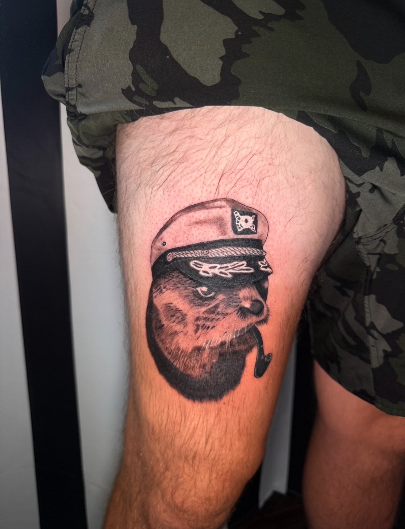 Portrait tattoo of bearded man in military captain hat, black and grey